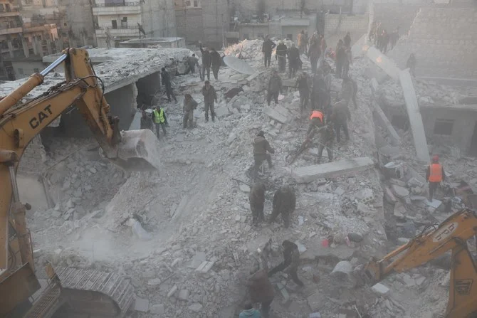 Dozens of firefighters, first responders and residents covered in debris and dust were searching through the rubble for the remaining residents with drills and a bulldozer. (Photo courtesy: ANHA)