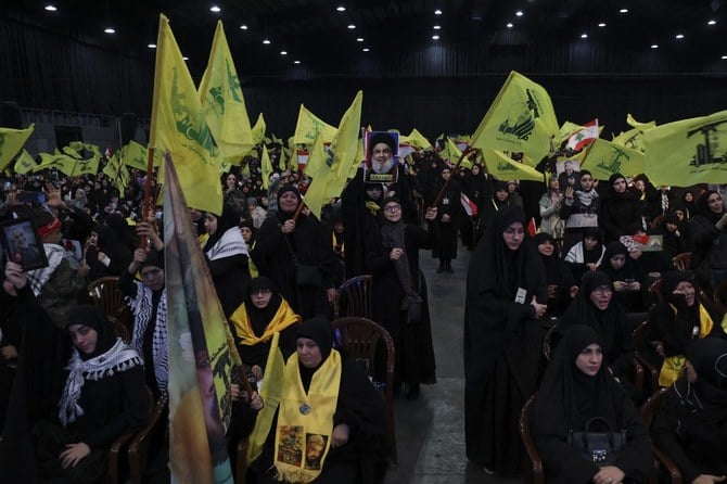 Supporters of Hezbollah attend a televised speech by the group’s leader Hassan Nasrallah in Beirut’s southern suburbs. (File/AFP)