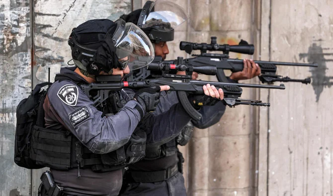 Israeli forces take aim during clashes with Palestinians in east Jerusalem’s Shuafat refugee camp following an operation to destroy a Palestinian home. (AFP)