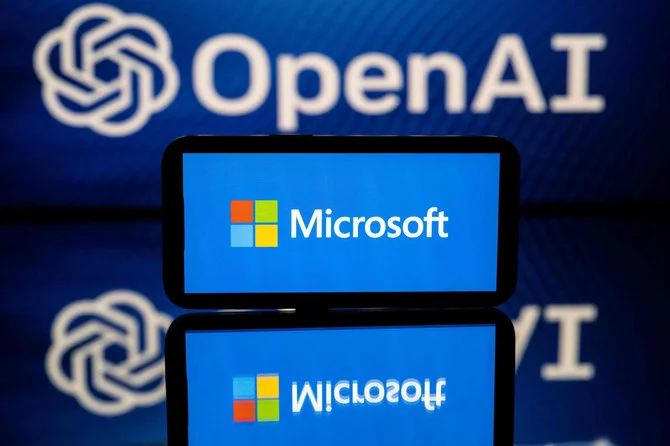 This picture taken on January 23, 2023 shows screens displaying the logos of Microsoft and OpenAI, a conversational artificial intelligence application software developed by OpenAI. (AFP)