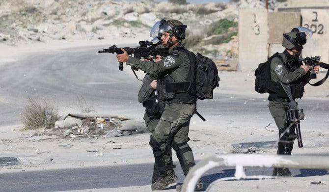 Israeli troops aim their weapons during confrontations with Palestinian demonstrators in the West Bank town of Al-Ram on January 27, 2023, a day after a deadly Israeli raid on the Jenin camp. (AFP)
