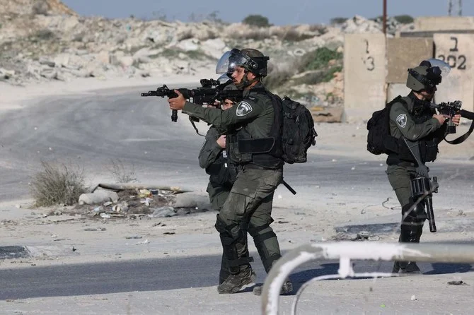 Israeli troops aim their weapons during confrontations with Palestinian demonstrators in the West Bank town of Al-Ram on January 27, 2023, a day after a deadly Israeli raid on the Jenin camp. (AFP