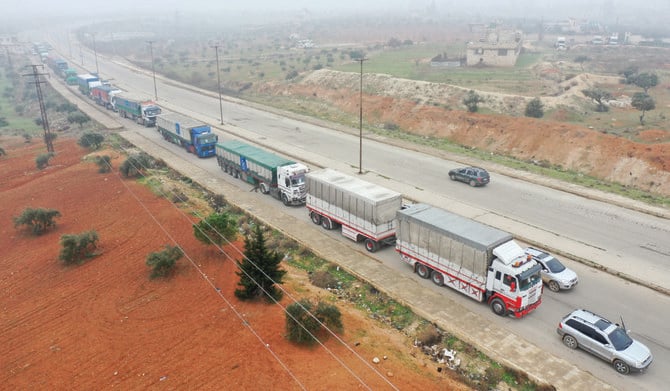 Trucks from the World Food Programme drive through the Syrian city of Idlib. (AFP)