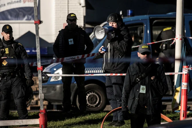 Danish police surround Rasmus Paludan ahead of his burning of a copy of the Qur’an in Copenhagen, Jan. 27, 2023. (Ritzau Scanpix/Reuters)
