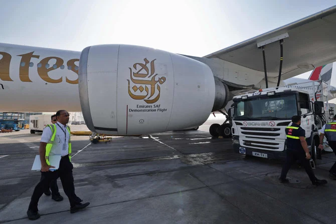 Emirates aircraft technicians prepare a Boeing 777-300ER on Jan. 30, 2023 at Dubai airport for a demonstration flight using sustainable aviation fuel. (AFP)