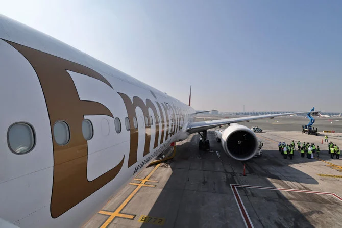 Emirates aircraft technicians prepare a Boeing 777-300ER on Jan. 30, 2023 at Dubai airport for a demonstration flight using sustainable aviation fuel. (AFP)