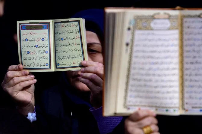 Protesters hold copies of the Qur’an in front of the Consulate General of Sweden in Istanbul. (File/AFP)