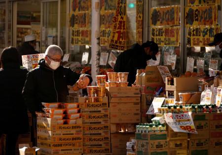 Shoppers check foods at a supermarket in Tokyo, Japan, January 10, 2023. (Reuters)