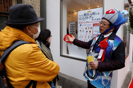 President of the Japanese whale-hunting company Kyodo Senpaku Kaisha Ltd, Hideki Tokoro, talks with customers, at the opening ceremony of his company's shop in Yokohama, Japan, January 24, 2023. (Reuters)