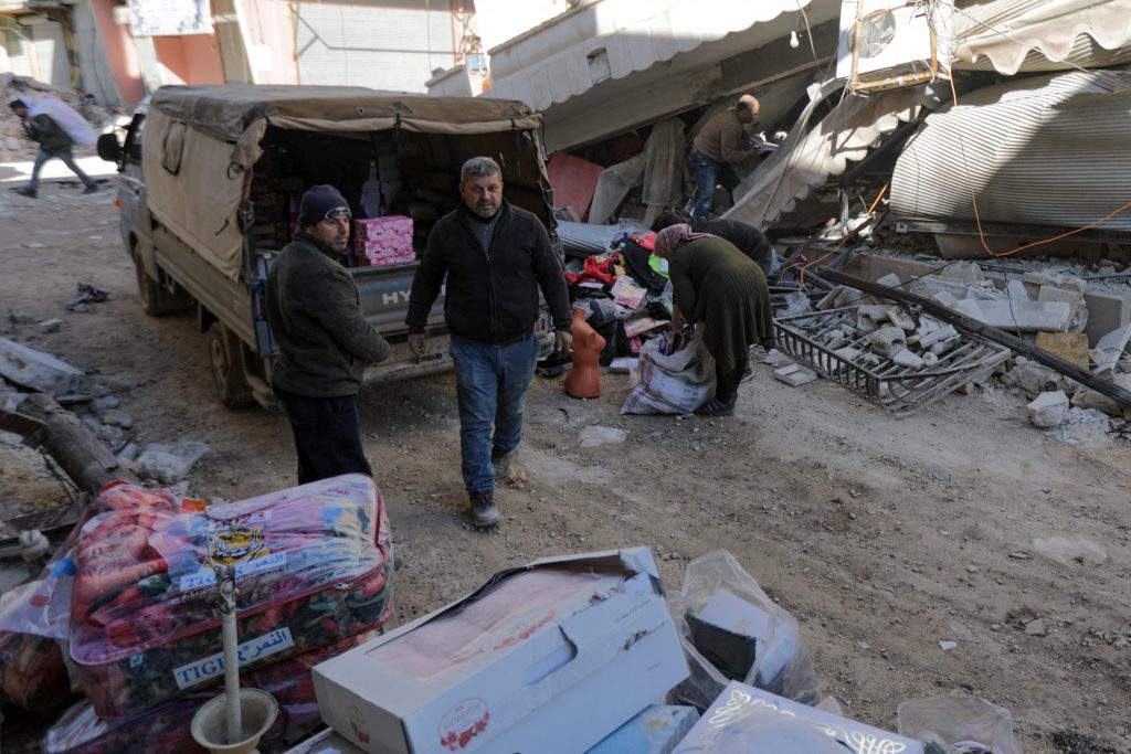 People try to salvage what remains of their shop before leaving the town of Jandaris, in Syria's rebel-held part of Aleppo province on February 9, 2023. (AFP)