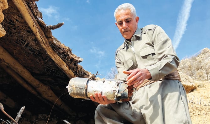 A Sararo villager shows the damage he says was caused by Turkish forces’ bombardment in Dohuk, Iraq, on Dec. 27, 2022. (Reuters)
