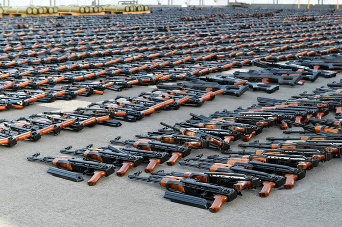 Assault rifles and missiles seized by the French navy lay on the deck of a ship at an undisclosed location. (AFP)