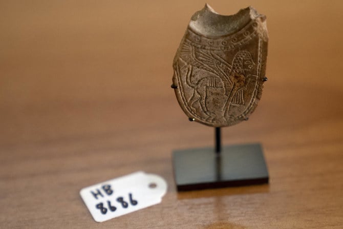 A 2,700-year-old ivory incense spoon plundered from a site in the occupied West Bank and seized in late 2021 by the Manhattan District Attorney’s office, displayed at the Palestinian Ministry of Tourism and Antiquities on Jan. 19, 2023. (AP)