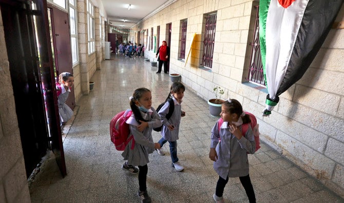 Palestinian pupils arrive on the first day of school in Ramallah on August 17, 2021. (AFP/File)