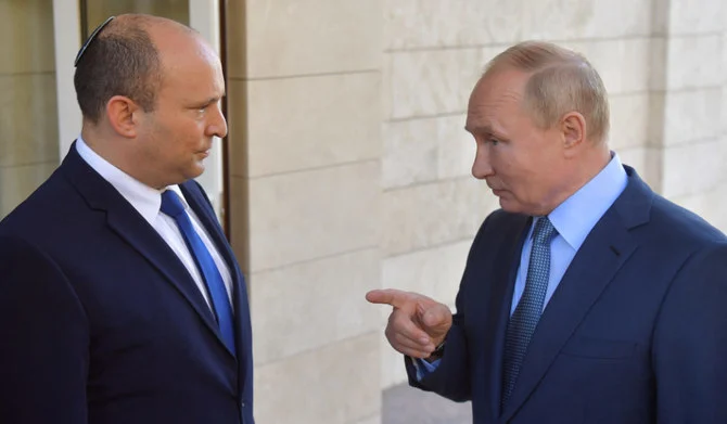 Russian President Vladimir Putin (R) speaks with Israeli Prime Minister Naftali Bennett during their meeting, in Sochi, on October 22, 2021. (AFP)