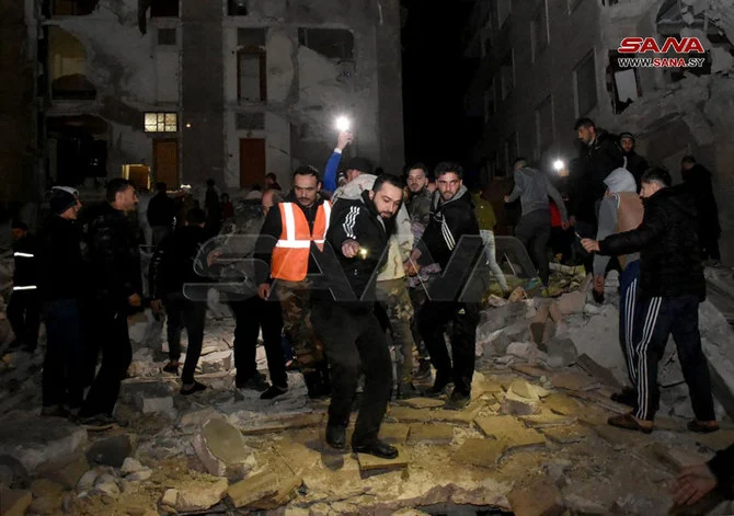Rescuers evacuate a victim from an 8-story building that collapsed in Hama, Syria after an 7.8-magnitude earthquake in southern Turkiye on Feb. 6, 2023. (SANA handout via AFP)