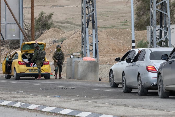Isreali soldiers inspect a car at a checkpoint at the entrance of Jericho city in the occupied West Bank, on February 4, 2023, following an Israeli morning raid at the Aqabat Jabr refugee camp. (File/AFP)