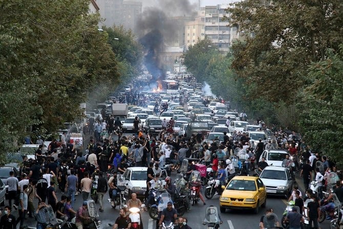 Protesters chant slogans during a protest over the death of Mahsa Amini who was detained by the morality police, in downtown Tehran, on Sept. 21, 2022. (AP/File Photo)