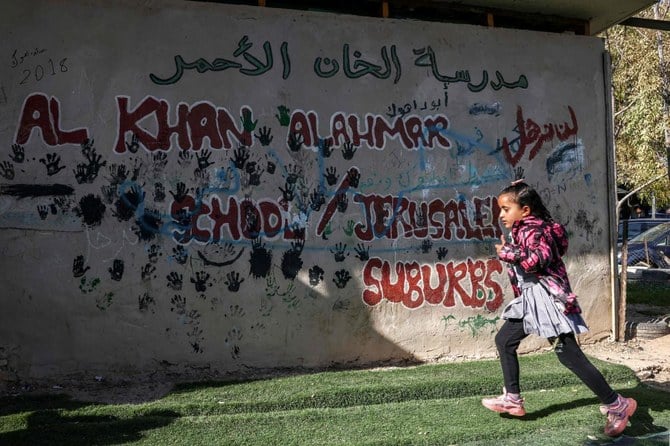 A girl runs outside a school in the Bedouin village of Khan Al-Ahmar in the occupied West Bank, near the east Jerusalem suburb of Abu Dis, Jan. 23, 2023. (AFP)
