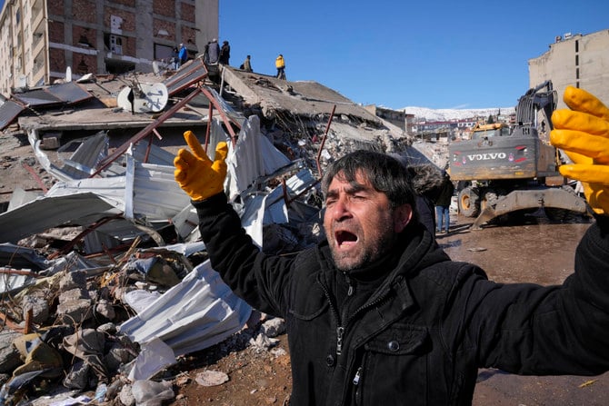 A man reacts after rescue teams found his father dead under a collapsed building, in Kahramanmaras, southern Turkey, on Feb. 8, 2023. (AP Photo)