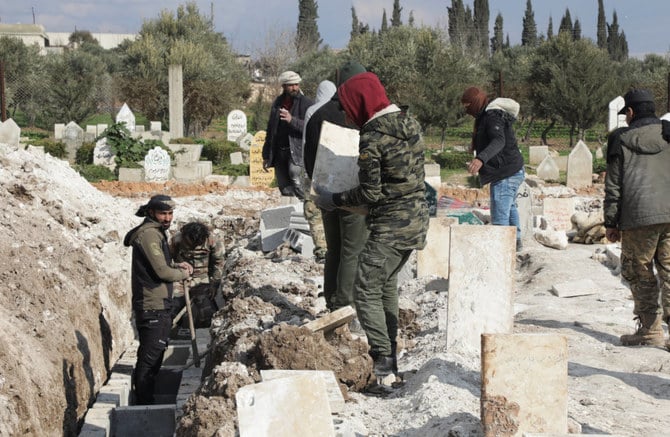 Volunteers prepare graves for earthquake casualties in rebel-held town of Jandaris, in Aleppo, Syria on Feb. 10, 2023. (REUTERS/Mahmoud Hassano)