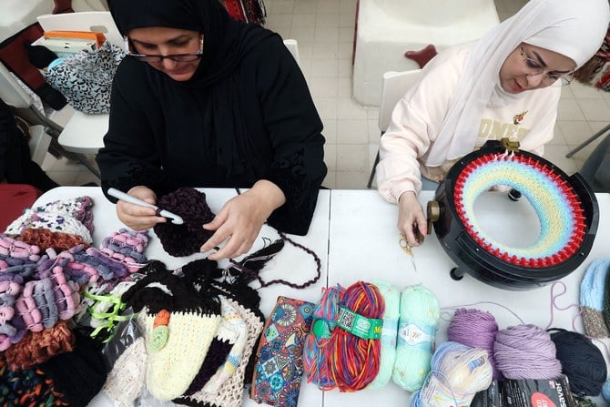 Kuwaiti women produce warm scarves and hats in Kuwait City on Feb. 11, 2023 to be sent to those affected by the deadly earthquake that hit Turkiye and Syria. (AFP)