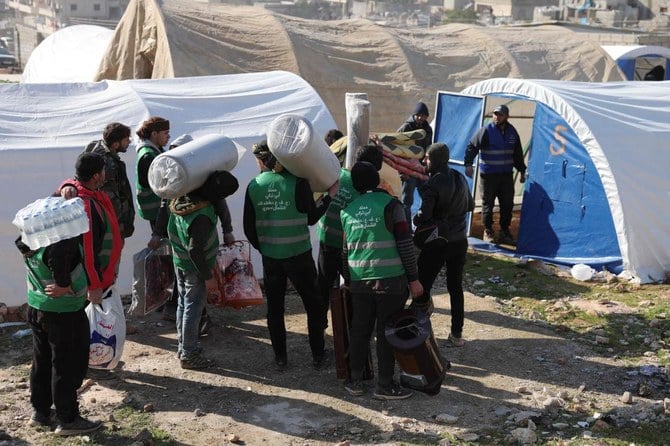 Syrians build a temporary camp, to house families made homeless by a deadly earthquake, in the town of Harim in Syria’s rebel-held northwestern Idlib province on the border with Turkiye, on Feb. 8, 2023. (AFP)