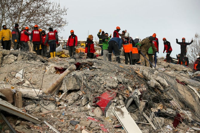 Rescue workers search for survivors on a collapsed building in Malatya, eastern Turkiye, on Feb. 8, 2023. Among those found dead in Malatya was a Yemeni doctor, Hamedi Al-Ghazali, and his wife. (AP)