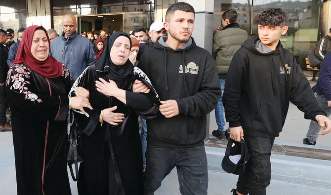 The mother and relatives of a young Palestinian boy react on Sunday after he was reportedly shot dead by Israeli forces during confrontations in the West Bank town of Jenin. (AFP/File)
