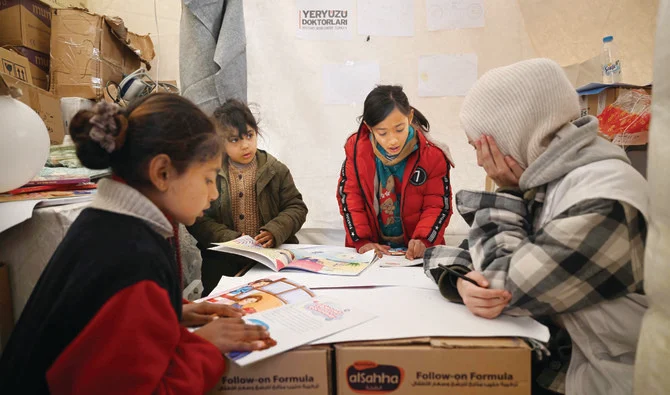 A psychologist takes care of children who have been affected by the earthquake in the province of Kahramanmaras, Turkiye. (AFP)