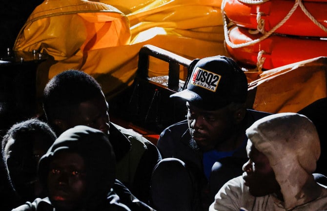 Migrants wait to disembark from a Spanish coast guard vessel, in the port of Arguineguin, in the island of Gran Canaria, Spain, Feb. 14, 2023. (Reuters)
