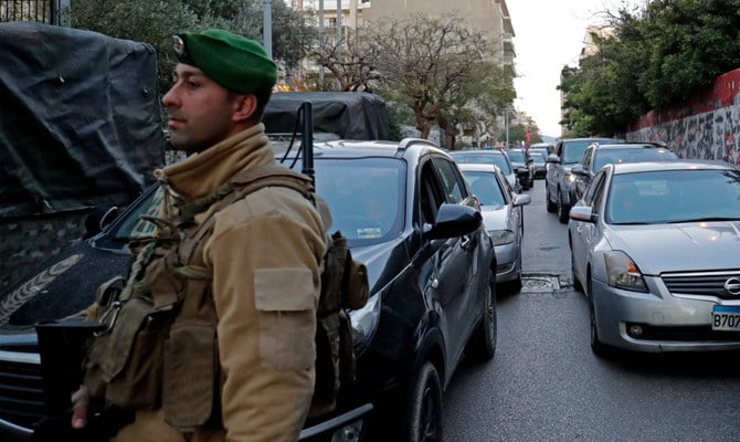 Drivers wait as traffic is brought to a hault in front of the interior ministry and the central bank on February 15, 2023, by a sit in staged by taxi drivers to show discontent due to the rising cost of living and the continuing devaluation of the Lebanese Lira. (AFP)