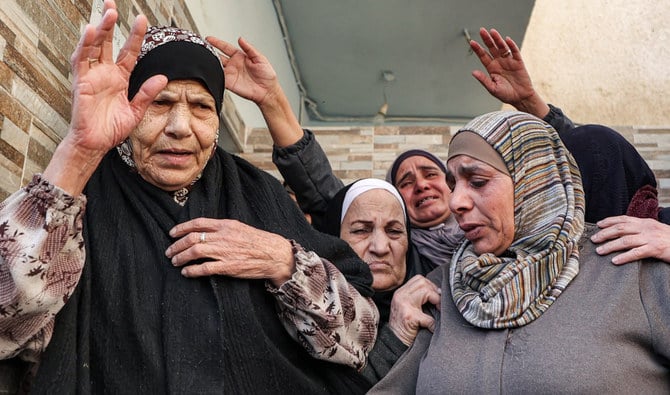 Mourners react during the funeral of 17-year-old Palestinian Mahmud Majid Mohammed Al-Aidi at Al-Fara refugee camp, north of Nablus in the occupied West Bank. Israeli troops shot dead Al-Aidi early on February 14. (AFP)