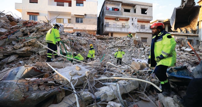 An Emirati search and rescue team searches through rubble in northwest Syria. (AFP)