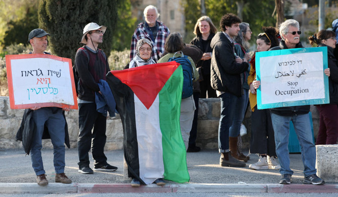 Protesters wave the Palestinian flag during a demonstration against the eviction of Palestinians from their homes, in the Israeli-annexed east Jerusalem neighbourhood of Sheikh Jarrah on February 17, 2023. (AFP)