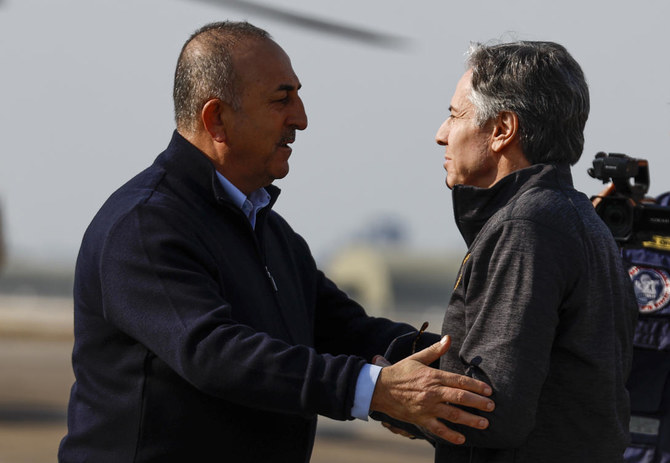 US Secretary of State Antony Blinken, right, is greeted by Turkish Foreign Minister Mevlut Cavusoglu, at Incirlik Air Base near Adana, Turkiye, Sunday, Feb. 19, 2023. (AP)