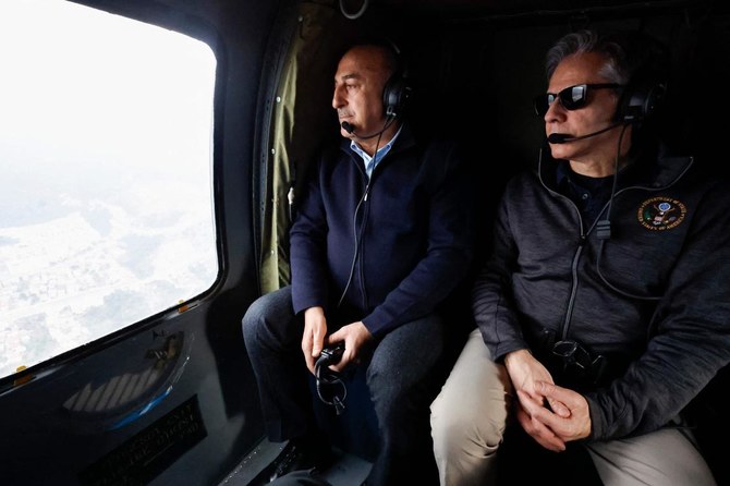 US Secretary of State Antony Blinken (R) and Turkish Foreign Minister Mevlut Cavusoglu sit in a helicopter for a tour of earthquake stricken areas on February 19, 2023. (AFP)