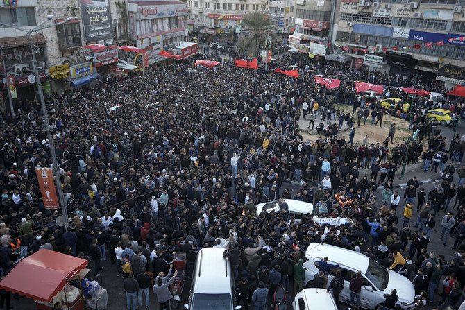 Palestinians carry the bodies of 10 men killed in clashes with Israel troops in the West Bank city of Nablus, on Feb. 22, 2023. (AP)