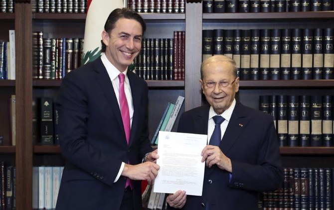 U.S. Envoy for Energy Affairs Amos Hochstein, left, and Lebanese President Michel Aoun hold a copy of the U.S.-brokered deal setting a sea border between Lebanon and Israel. (AP Photo)