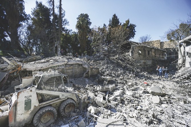 People inspect the damage in the aftermath of an Israeli airstrike, allegedly targeting a logistics center run by the IRGC, which killed five people and damaged several buildings in Syria’s capital Damascus on Sunday, Feb. 19. (AFP)