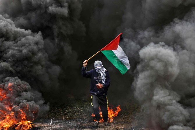 Palestinian youths burn tires during a protest near the Israel-Gaza border east of Jabalia refugee camp, on February 23, 2023. (AFP)