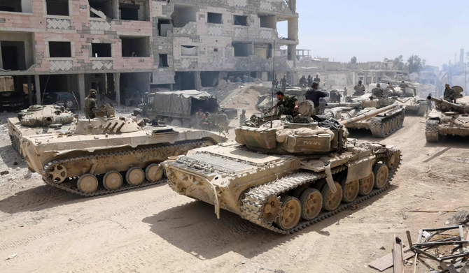 A picture taken on April 8, 2018, shows Syrian Army soldiers gathering in an area on the eastern outskirts of Douma, as they continue their fierce offensive to retake the last opposition holdout in Eastern Ghouta. (AFP)