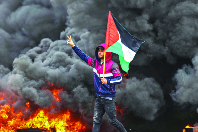 Palestinian youths burnt tires during a recent protest near the Israel-Gaza border, east of Jabalia refugee camp. (AFP)