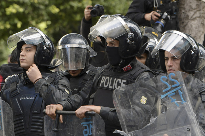 Tunisia police stand guard at a checkpoint outside the Interior Ministry during a demonstration against the President in Tunis on January 14, 2023. (AFP)