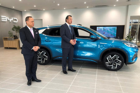 Atsuki Tofukuji, president of the Japanese unit of China's BYD Co Ltd, stands next to a car at the electric vehicle maker's first dealership in the country in Yokohama, Japan, January 31, 2023. (Reuters)