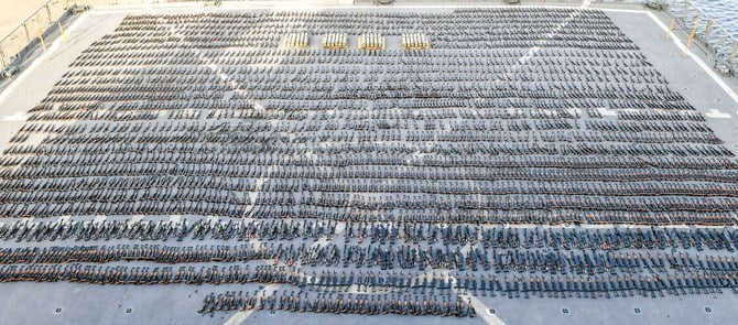 Assault rifles and missiles seized by the French navy lay on the deck of a ship at an undisclosed location. (Twitter: CENTCOM)