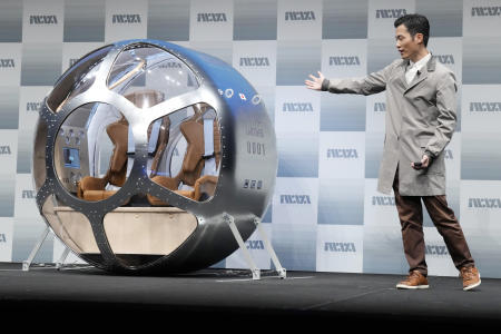 Keisuke Iwaya, CEO of a Japanese space development company, Iwaya Giken, unveils a two-seater cabin and a balloon that the company says is capable of rising to an altitude of 15 miles, which is roughly the middle of the stratosphere, as he speaks during a news conference in Tokyo, Tuesday, Feb. 21, 2023. (AP)