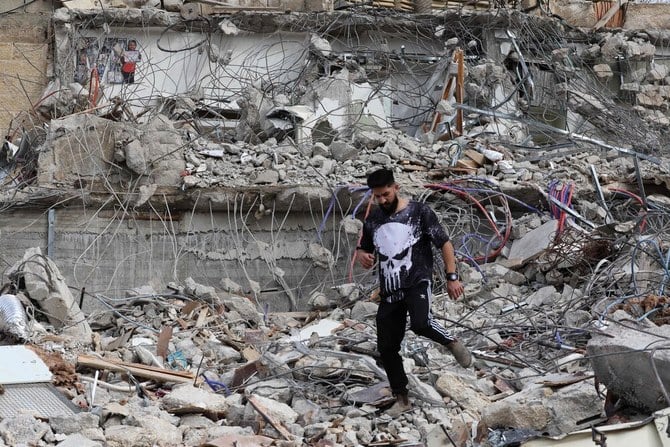 A Palestinian man walks amidst the debris of the house of Rateb Hatab Shukairat, after it was demolished by Israeli bulldozers, in the East Jerusalem neighbourhood of Jabal Mukaber on Jan. 29, 2023. (AFP)