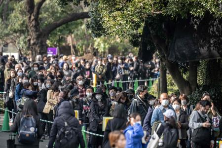 People wait in line to look at the female giant panda Xiang Xiang ahead of her return to China, at Ueno Zoological Park in Tokyo on February 19, 2023. (AFP)