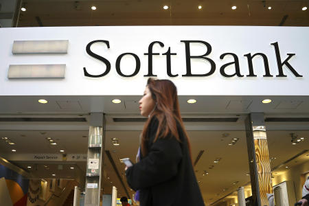 A woman walks in front of SoftBank store in Ginza shopping district in Tokyo, Jan. 20, 2020. (AP)